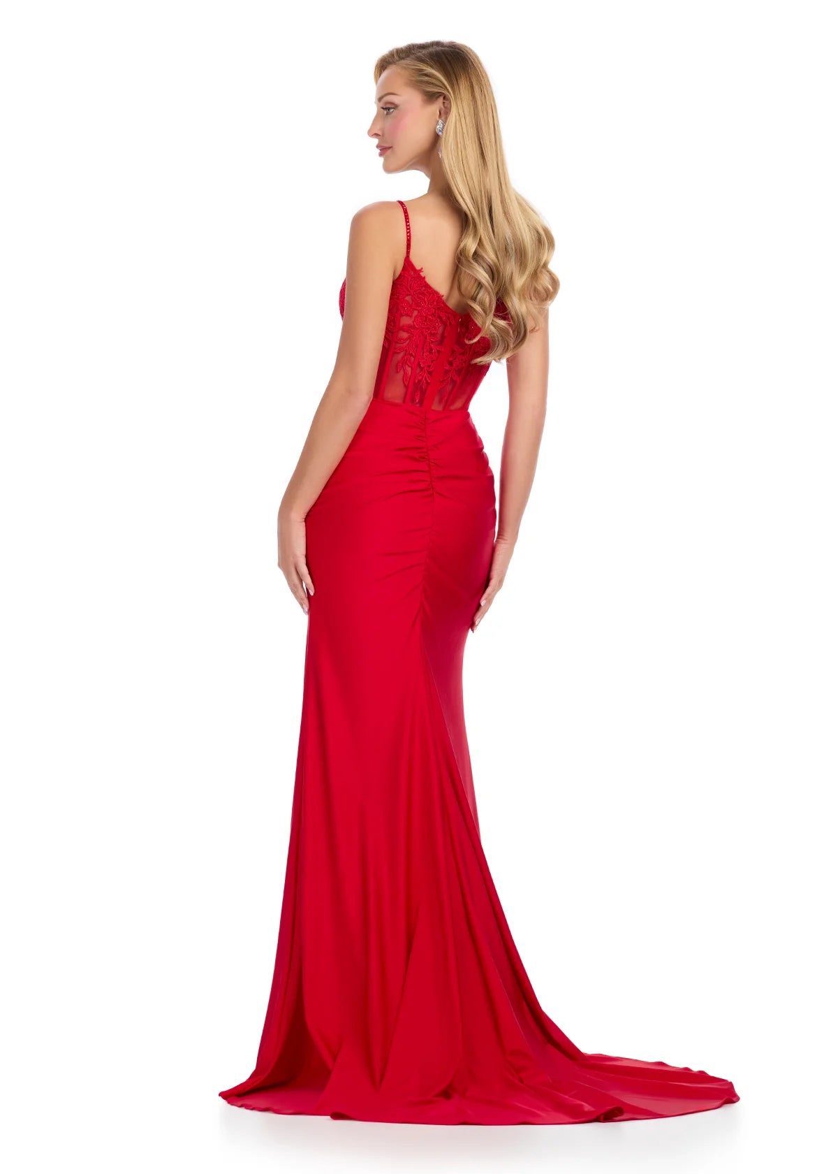 Back view of a stunning red evening gown featuring a sheer illusion bodice with floral lace appliqués, thin spaghetti straps, a thigh-high slit, and a flowing floor-length skirt.