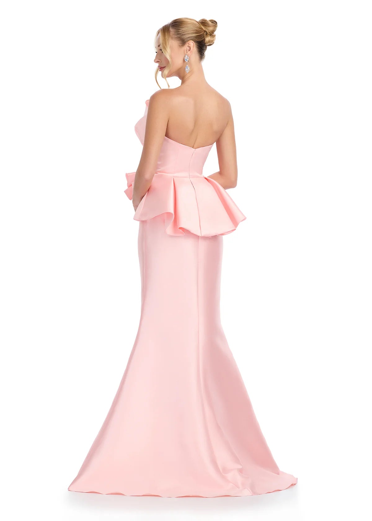 Back view of a plush pink mermaid gown featuring a strapless neckline with dramatic ruffle detailing, offering a chic and sophisticated look.