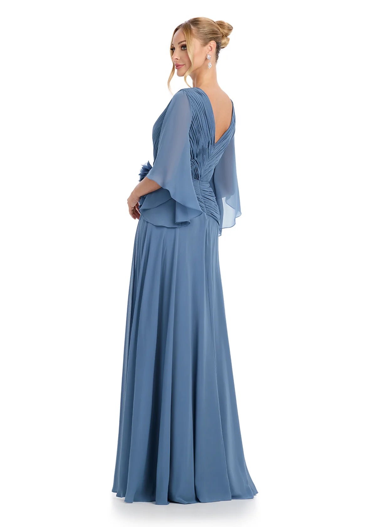 Back view - Graceful V-neck gown with flutter sleeves, pleated bodice detailing, and a statement floral embellishment at the waist, offering timeless sophistication.