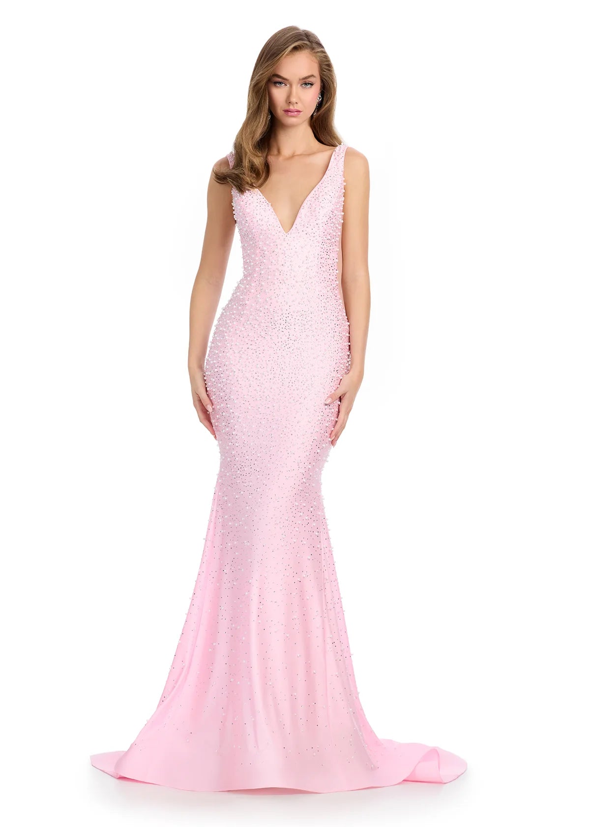 Pink v-neck fitted evening gown embellished with scattered crystals, featuring sheer side panels and a dramatic floor-sweeping train for a sophisticated and dazzling look.