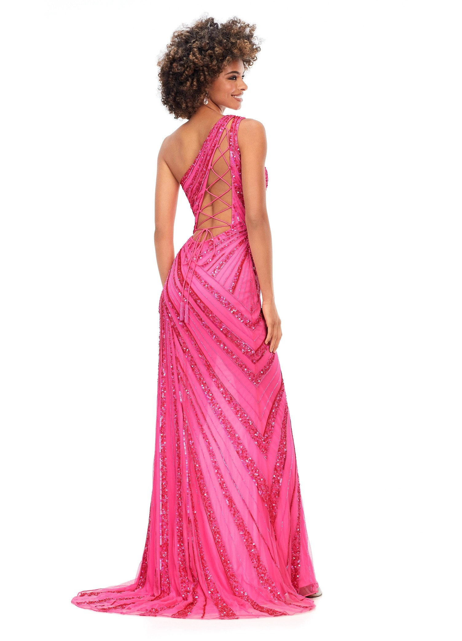 Back View - Pink one-shoulder gown with sparkling sequin details, fitted silhouette, and a thigh-high slit.