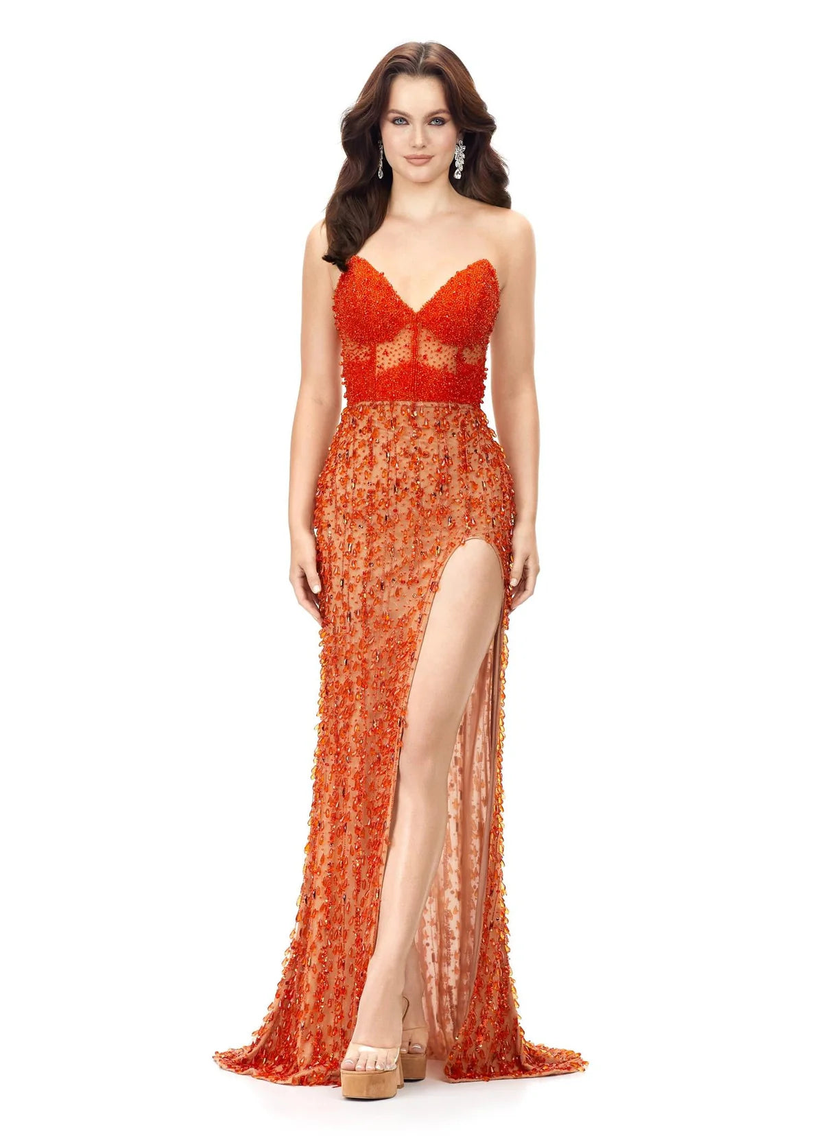 Orange embellished gown featuring a sweetheart neckline, sheer bodice details, and a high slit for a bold and glamorous look.