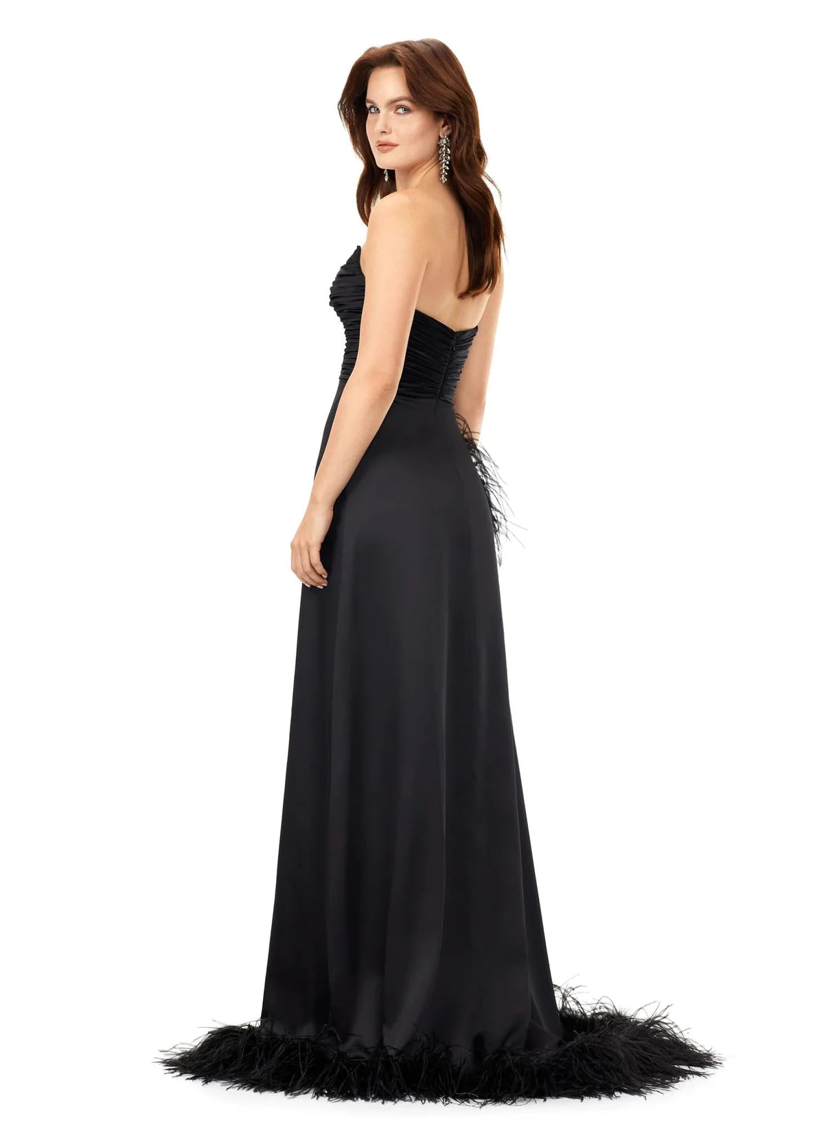 Back view - Elegant strapless evening gown featuring a ruched bodice and a dramatic feather-trimmed slit, exuding timeless sophistication and modern flair.