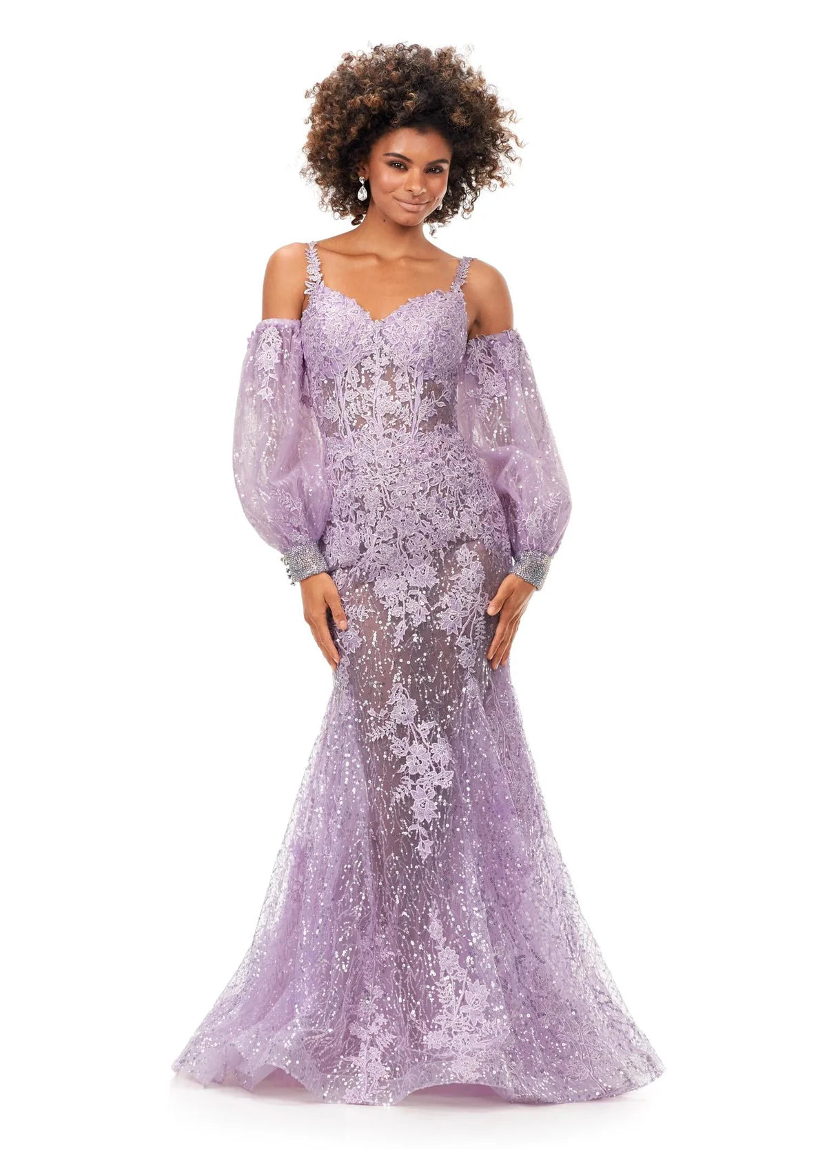 Lilac gown with a sweetheart neckline, sheer lace bodice, voluminous off-the-shoulder puff sleeves, fitted silhouette, and sequin embellishments cascading to a mermaid-style hem.