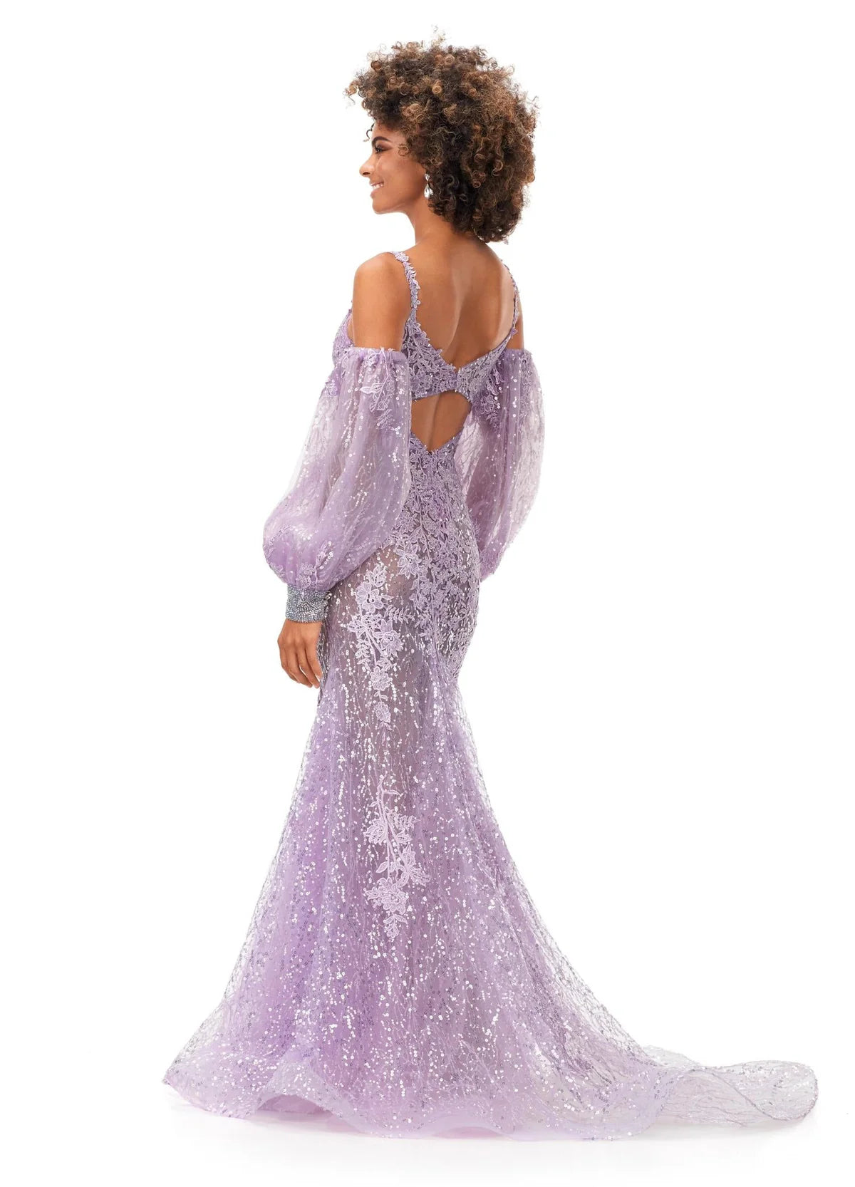 Back View - Lilac gown with a sweetheart neckline, sheer lace bodice, voluminous off-the-shoulder puff sleeves, fitted silhouette, and sequin embellishments cascading to a mermaid-style hem.