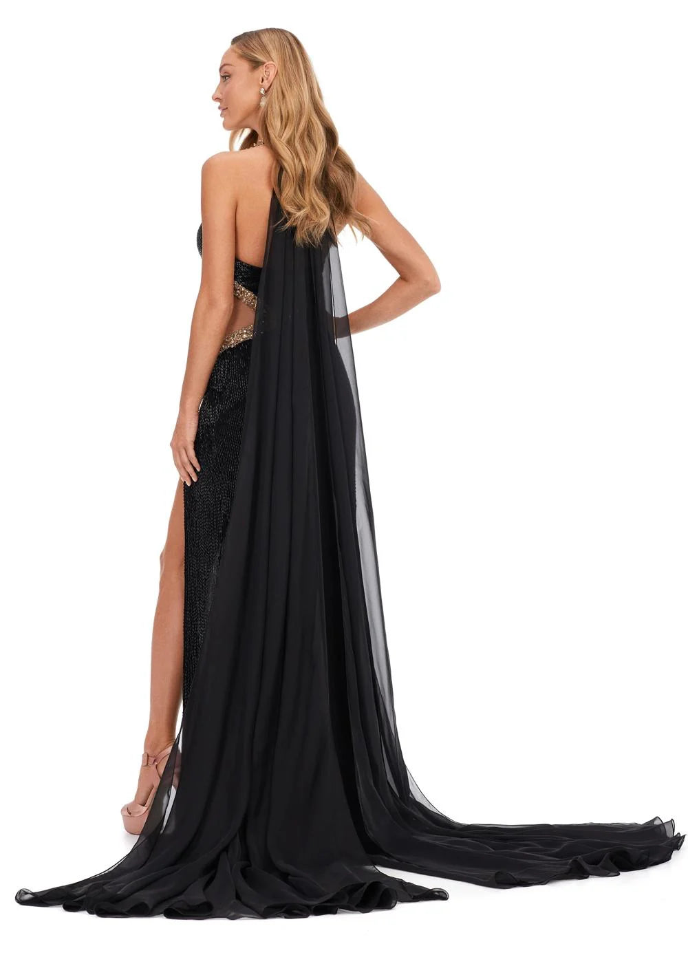 Back View - Black halter gown with gold embellishments, cut-out details, thigh-high slit, and flowing chiffon cape.