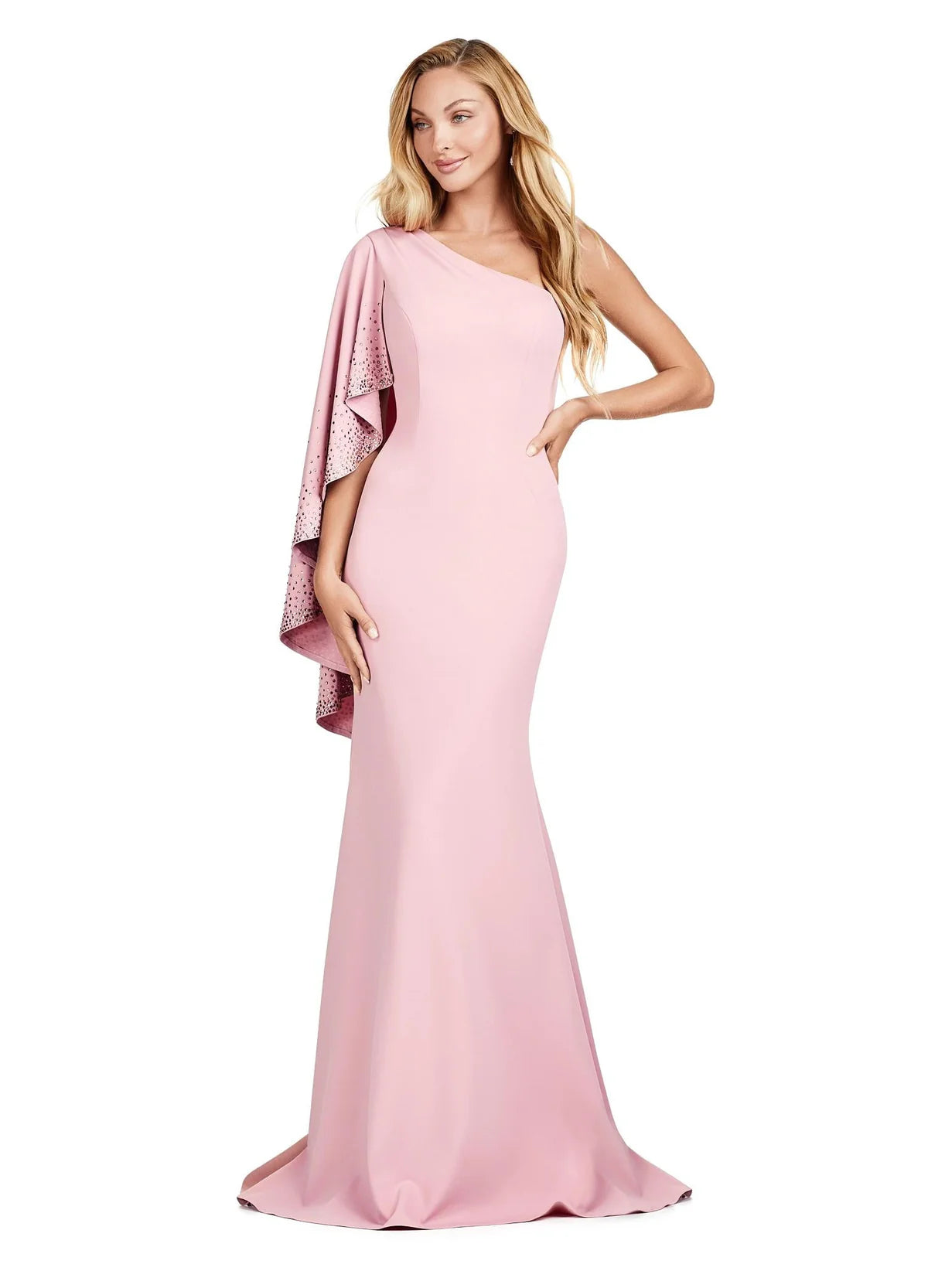 Chic soft pink gown featuring a one-shoulder design with a dramatic embellished cape sleeve, fitted silhouette, and floor-length hem for a timeless and elegant look.