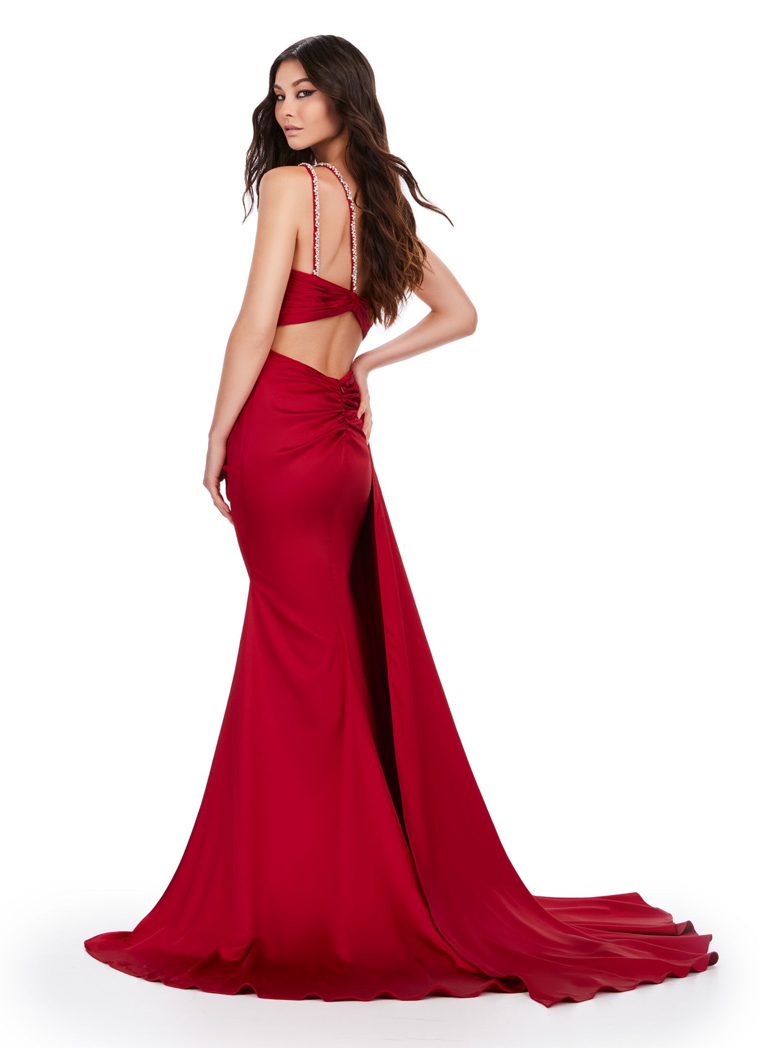 Back view - Elegant red floor-length gown featuring a one-shoulder design, draped bodice with sparkling embellishments, a thigh-high slit, and a flowing train for a sophisticated and glamorous look.