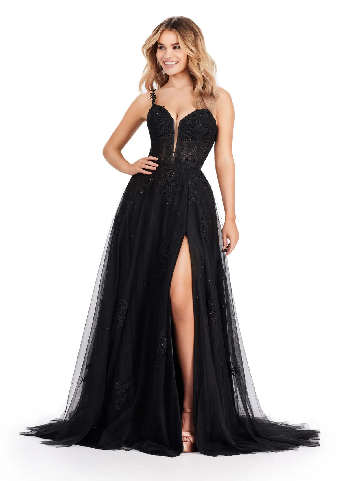 Black tulle ball gown featuring a sweetheart neckline, sheer bodice with lace appliqués, thigh-high slit, and a flowing layered skirt.