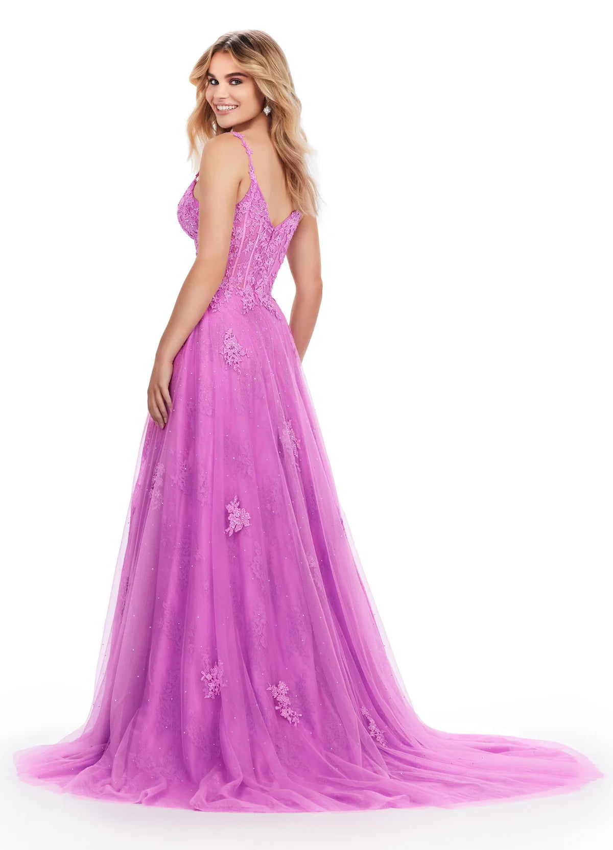 Back View - Pink tulle ball gown featuring a sweetheart neckline, sheer bodice with lace appliqués, thigh-high slit, and a flowing layered skirt.