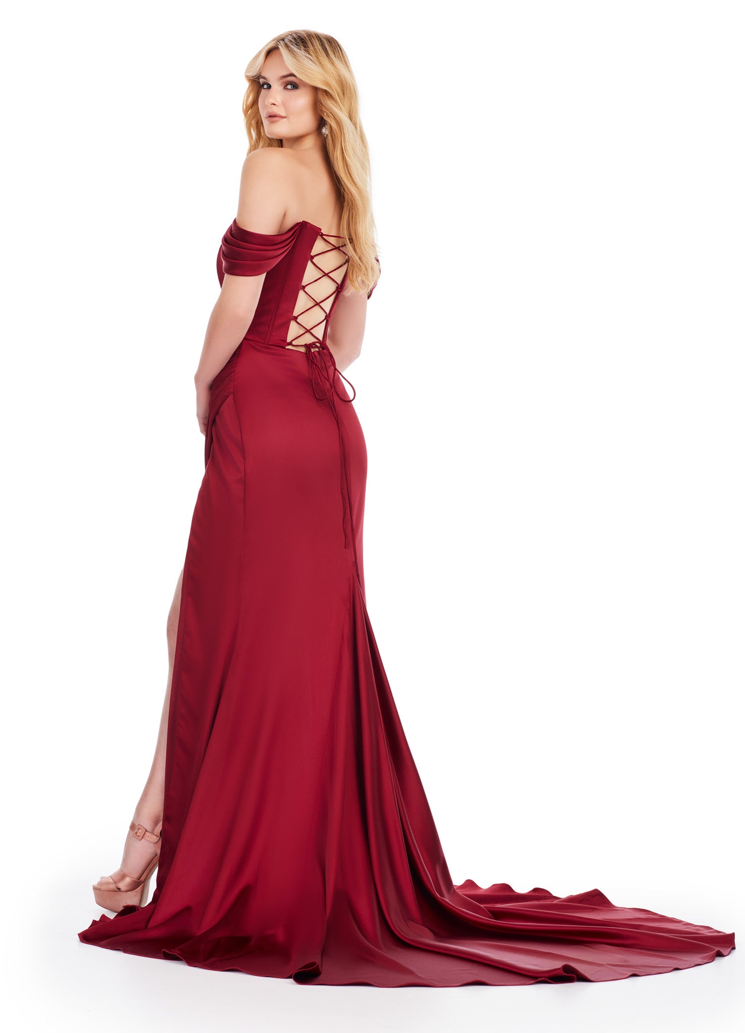 Back View - Off-the-shoulder burgundy evening gown featuring a corset-style bodice with pleated detailing, ruffled sleeve accents, a high leg slit, and a floor-length skirt with a slight train.