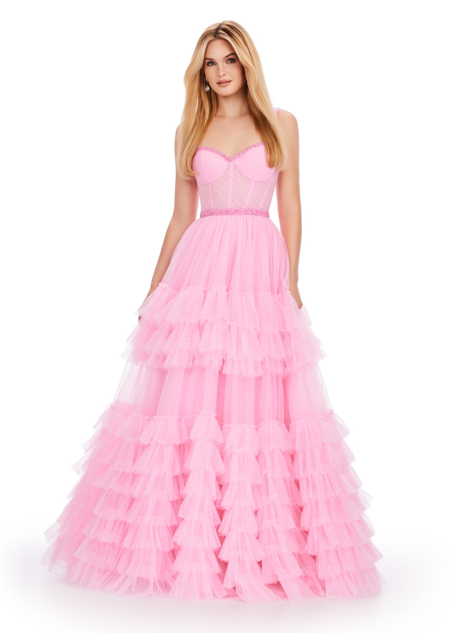 Pink ball gown with a sweetheart neckline, fitted bodice, embellished waistband, and tiered tulle skirt.