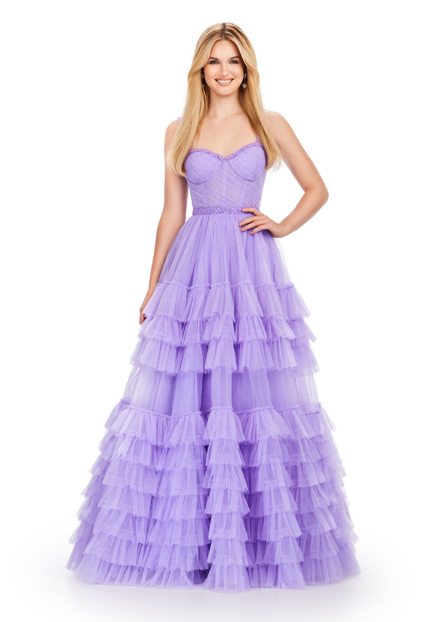 Lilac ball gown with a sweetheart neckline, fitted bodice, embellished waistband, and tiered tulle skirt.