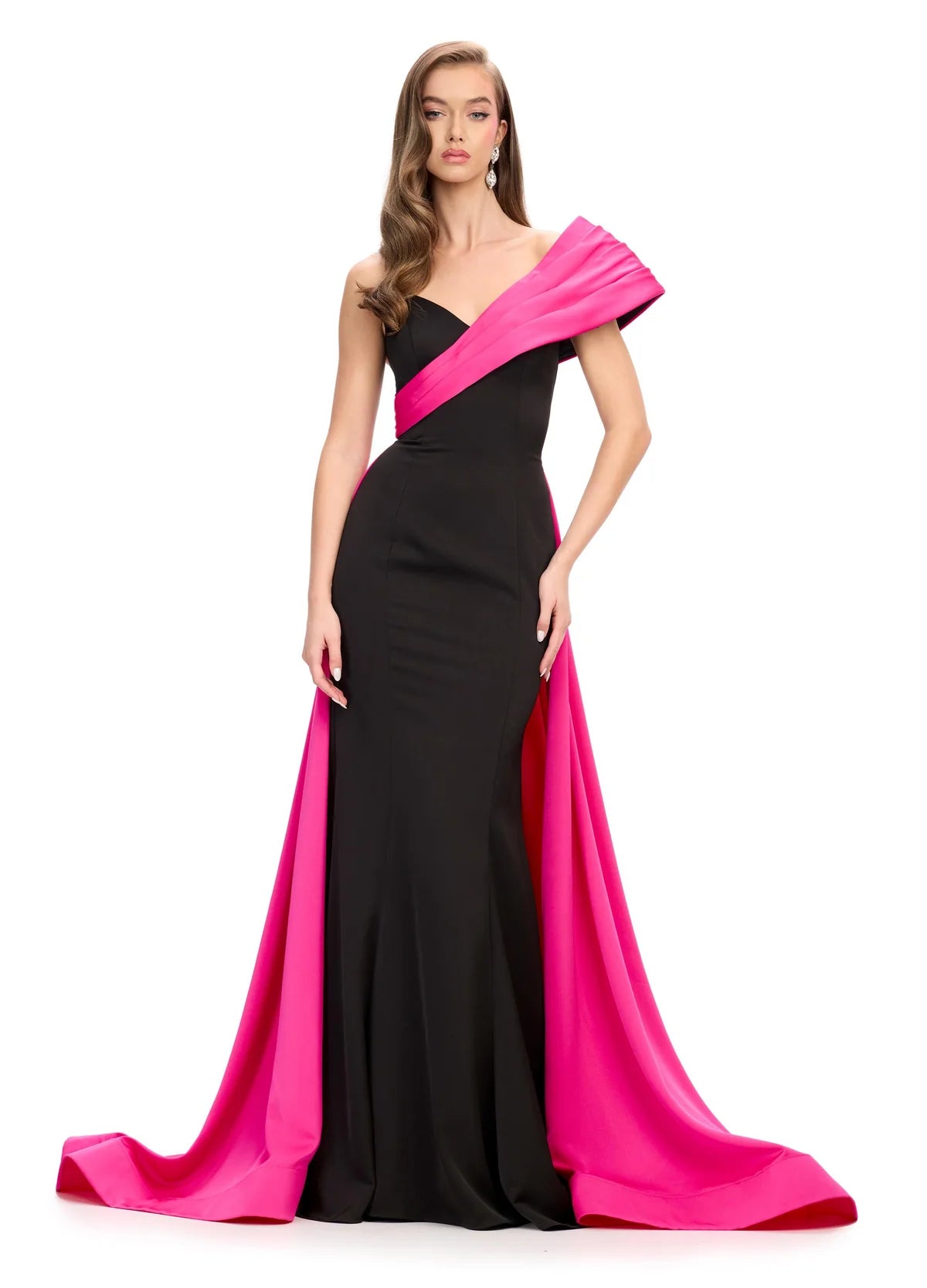 Black gown with an asymmetrical neckline, fitted silhouette, and dramatic pink off-the-shoulder draping that extends into a floor-length train.