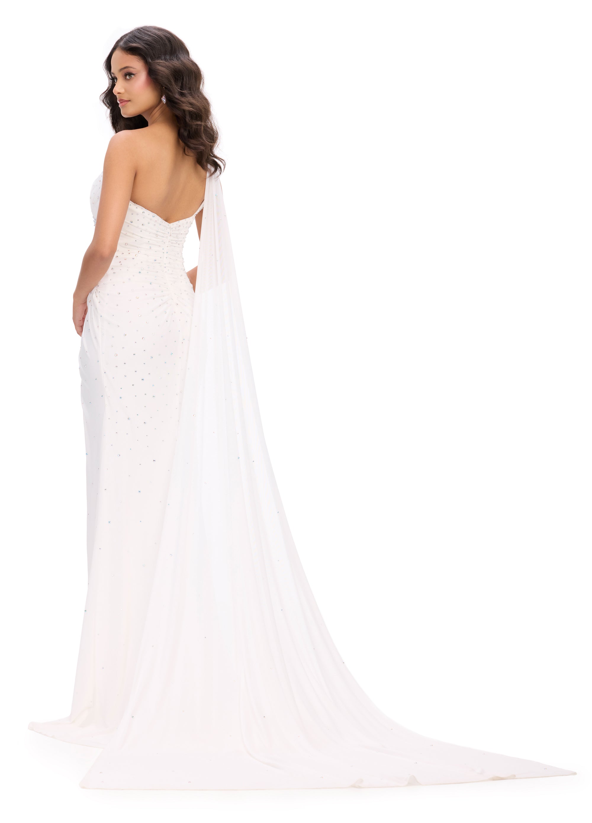 Back view - White asymmetric one-shoulder evening gown adorned with scattered embellishments, featuring a draped bodice, thigh-high slit, and a flowing sheer cape for a dramatic and elegant silhouette.