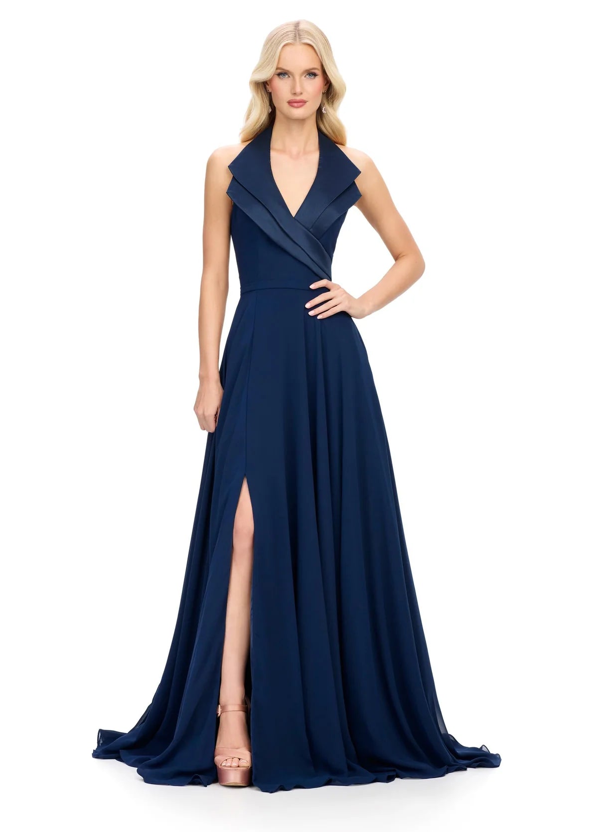  Halter-neck navy blue evening gown featuring a deep V-neckline with structured lapel detailing, a fitted waist, and a flowing floor-length skirt with a high slit.