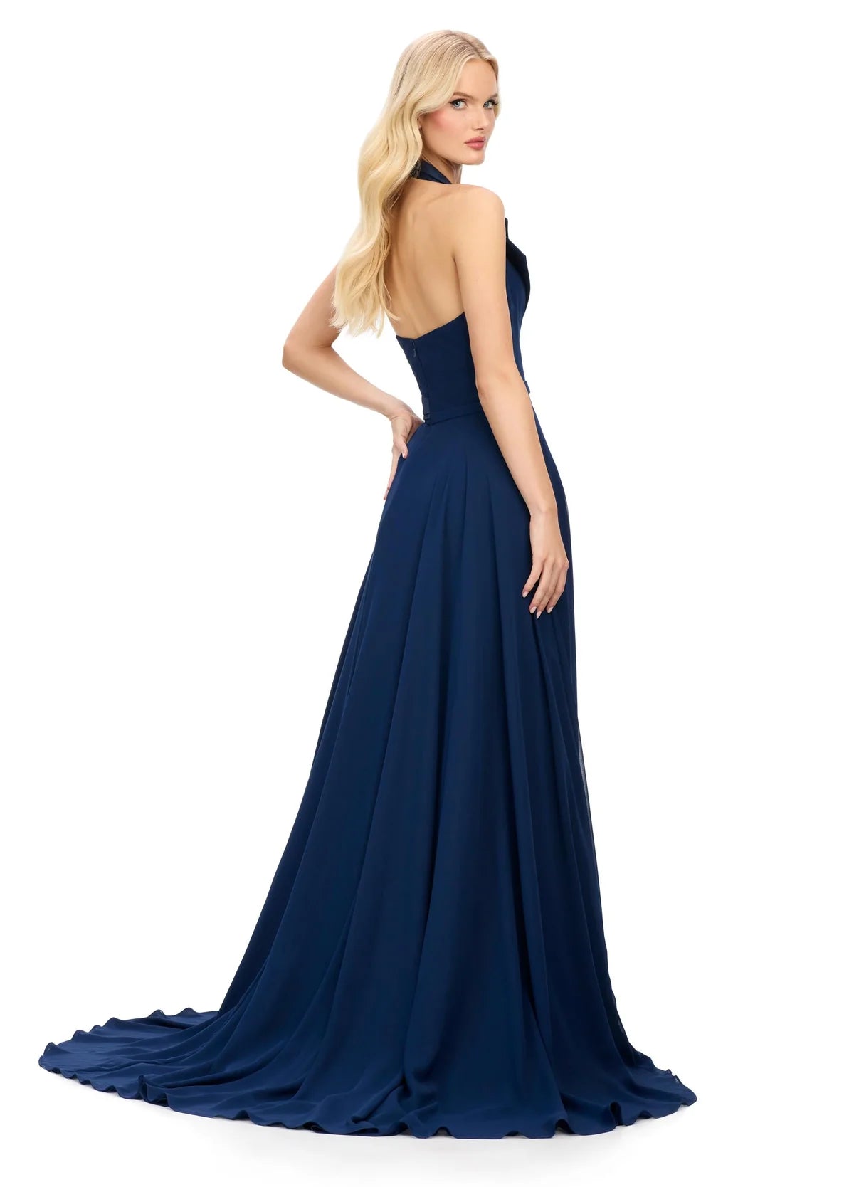 Back View -  Halter-neck navy blue evening gown featuring a deep V-neckline with structured lapel detailing, a fitted waist, and a flowing floor-length skirt with a high slit.