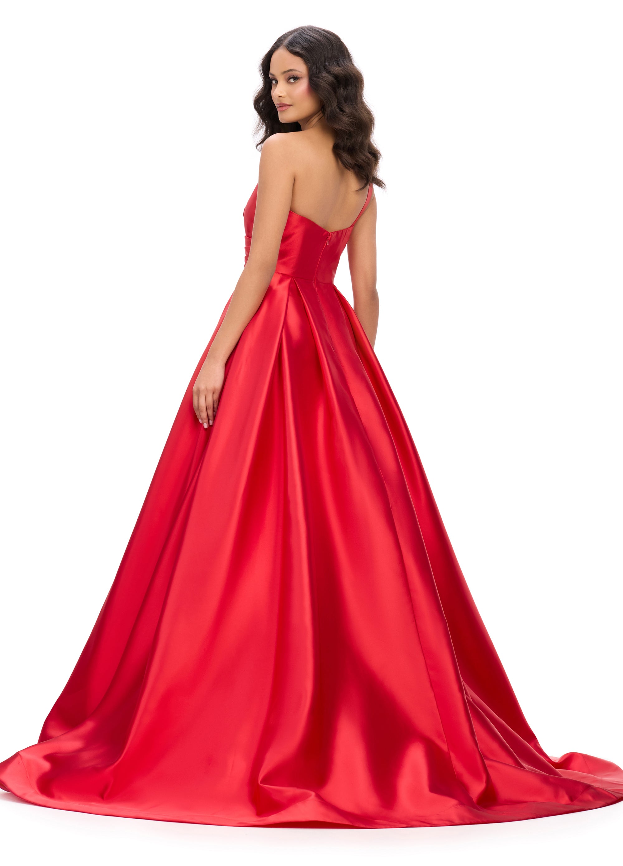 Back view of a striking red ball gown with a plunging neckline, wrap-style bodice, and a dramatic full skirt, perfect for an unforgettable evening look.