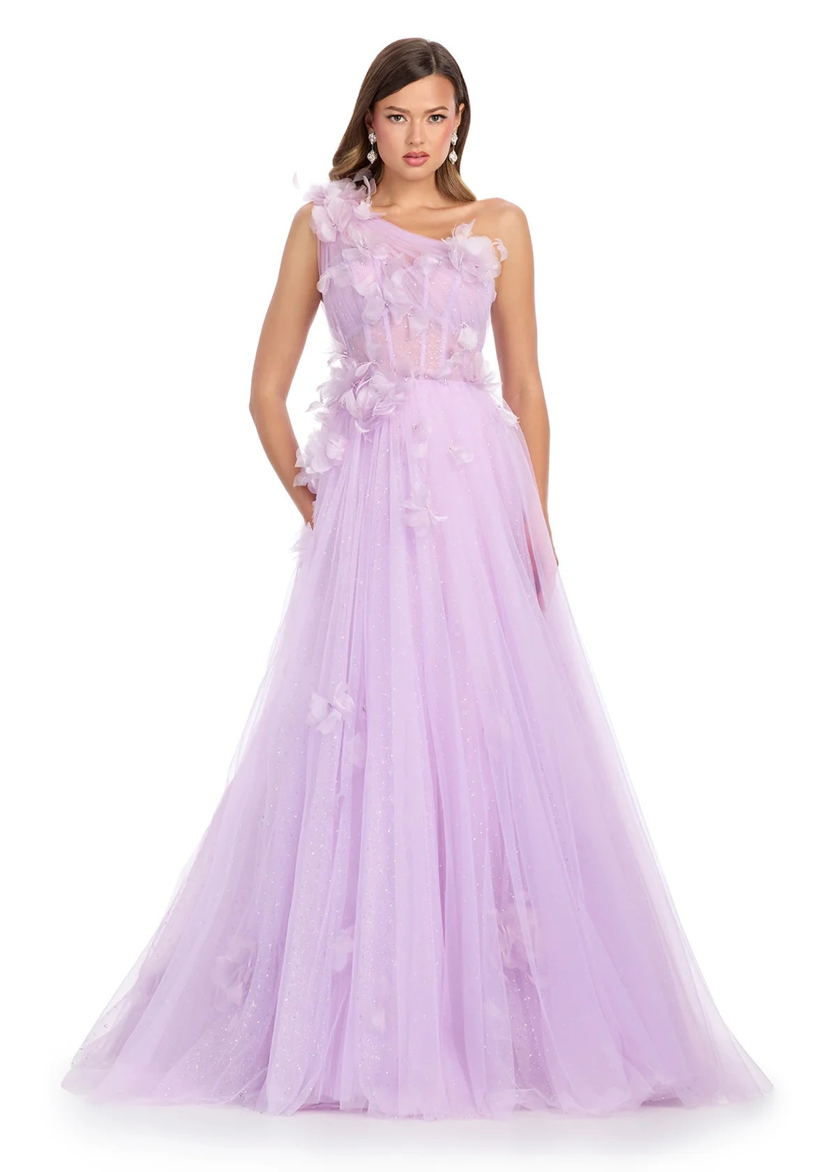 A lilac one-shoulder ball gown featuring delicate tulle layers adorned with soft floral appliqués, a semi-sheer corset bodice, and a romantic flowy skirt that glimmers subtly, perfect for an enchanting evening.