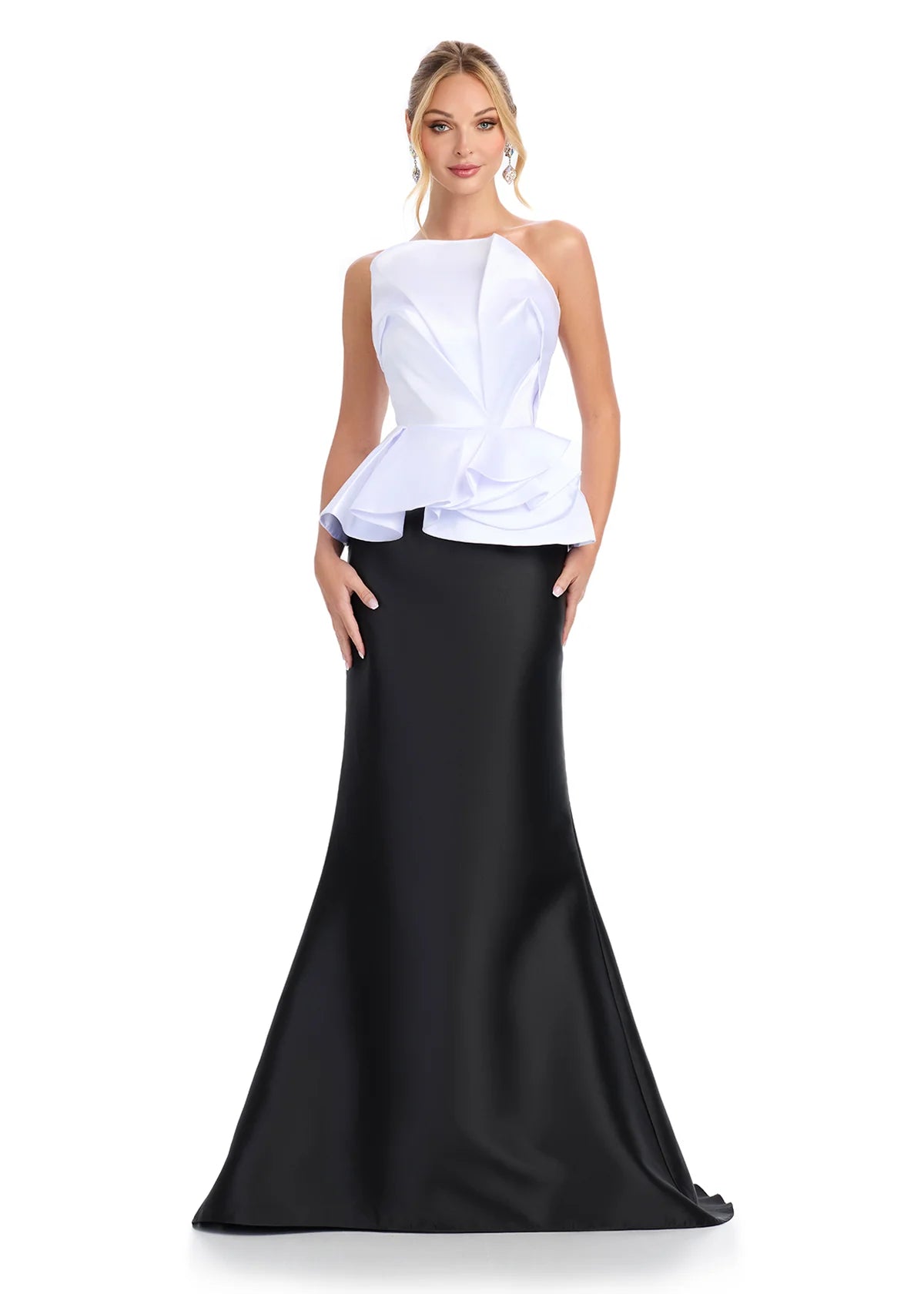 White and black evening gown featuring a strapless white peplum top with sculpted ruffle detailing and a sleek black mermaid skirt for a modern and elegant look.