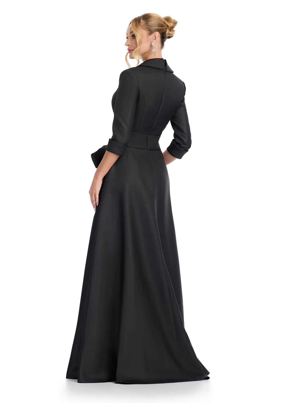 Back view of an elegant black evening gown with a tailored blazer-style top, three-quarter sleeves, and a statement waist bow, offering a sophisticated and timeless look for formal events.