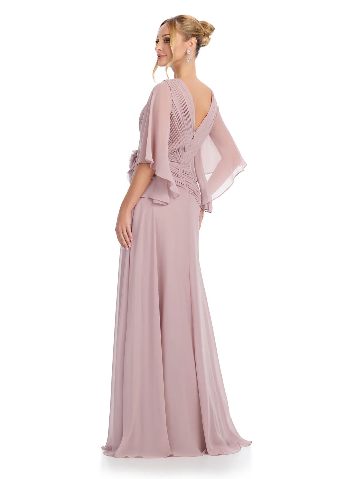 Back view - Graceful taupe V-neck gown with flutter sleeves, pleated bodice detailing, and a statement floral embellishment at the waist, offering timeless sophistication.