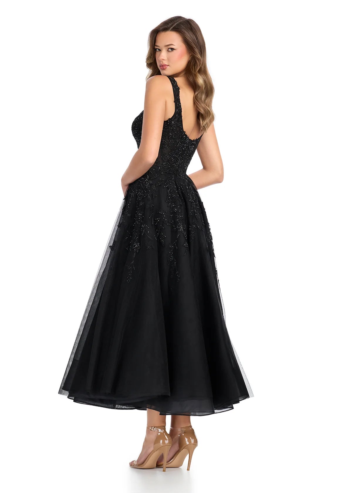 Back view - Black midi dress featuring a sheer lace bodice with intricate beadwork, wide straps, and a voluminous A-line skirt, combining sophistication with modern elegance.