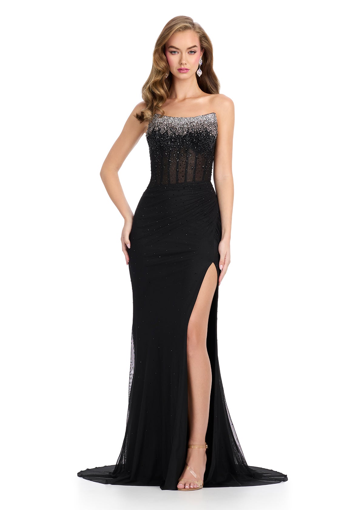 Elegant evening gown featuring a strapless design, gradient beaded bodice, sheer detailing, and a floor-length skirt with a thigh-high slit.