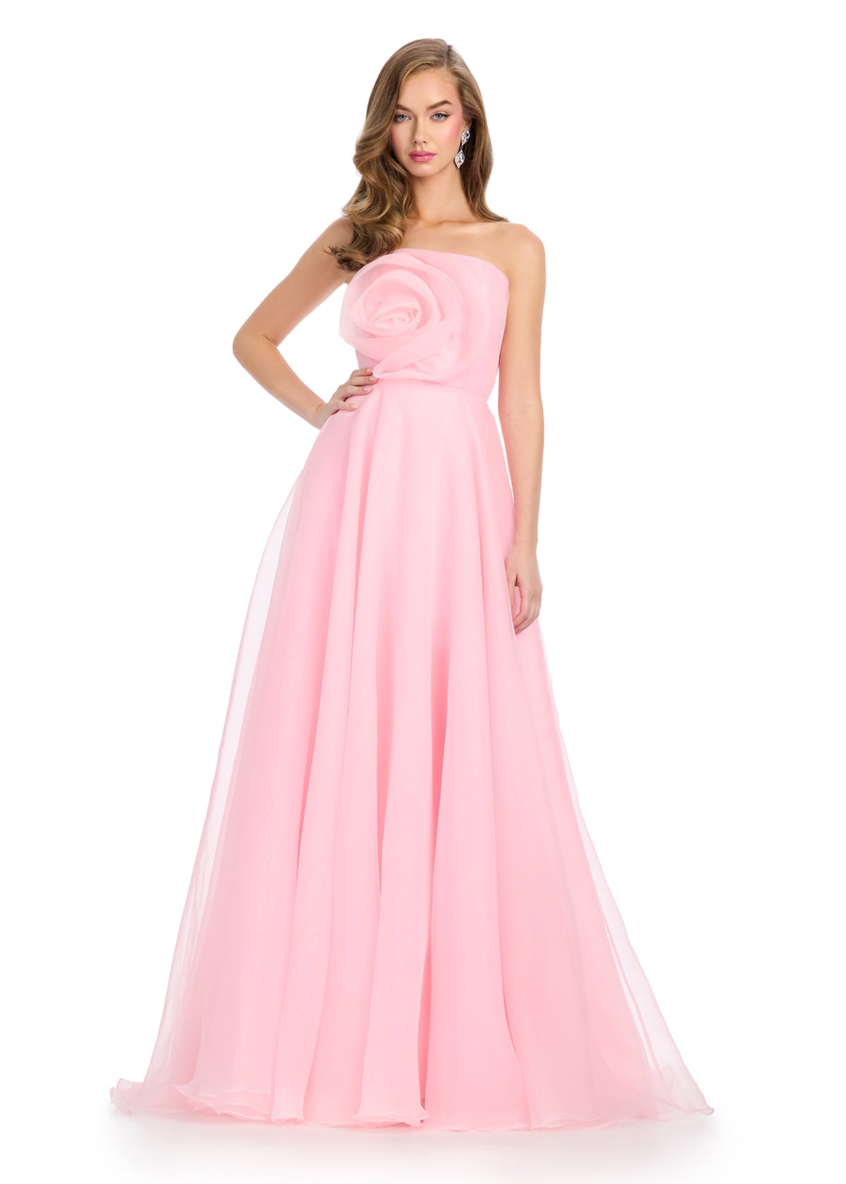 Strapless light pink gown with a large rose detail on the bodice and a flowing A-line silhouette.