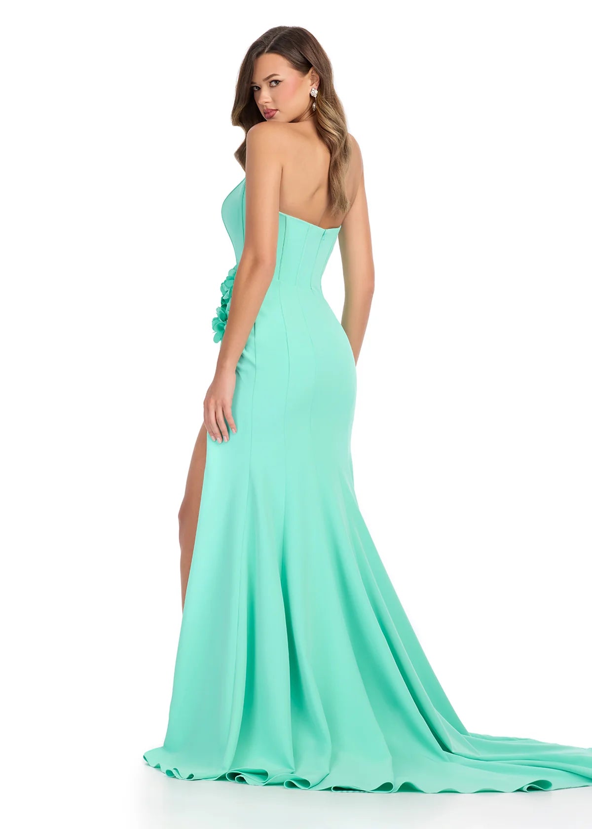 Back View - Mint green gown with a strapless corset-style bodice, floral accents at the waist, high slit, and floor-length fitted silhouette.