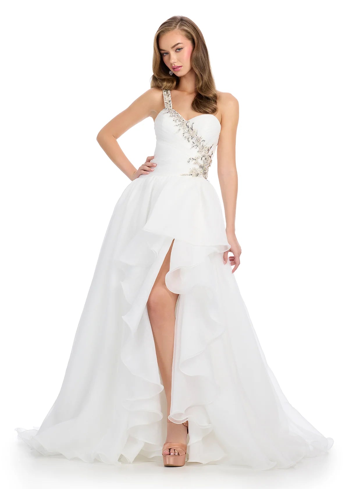 White strapless ball gown featuring a sweetheart neckline, floral embellishments, cascading ruffles, and a high slit for a dramatic and romantic silhouette.