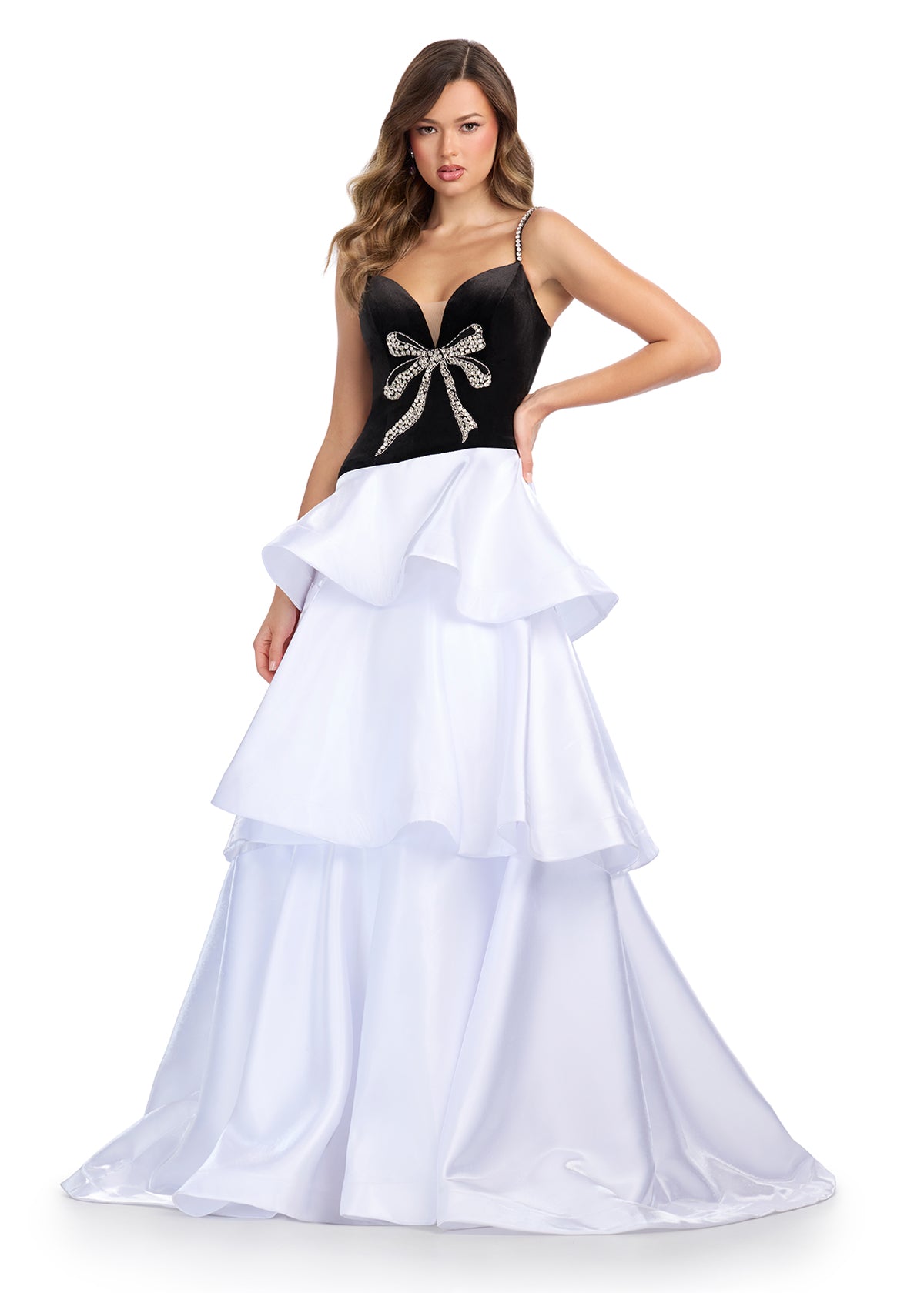 Black and white tiered ball gown featuring a velvet bodice with crystal bow detail and flowing layered skirt.