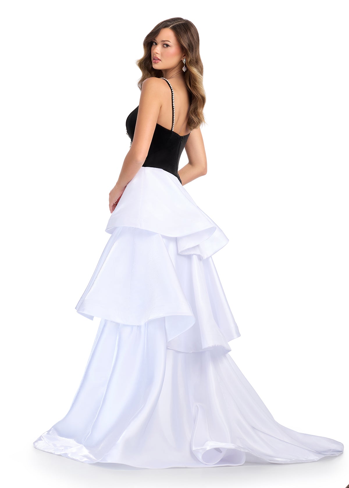 Back View - Black and white tiered ball gown featuring a velvet bodice with crystal bow detail and flowing layered skirt.