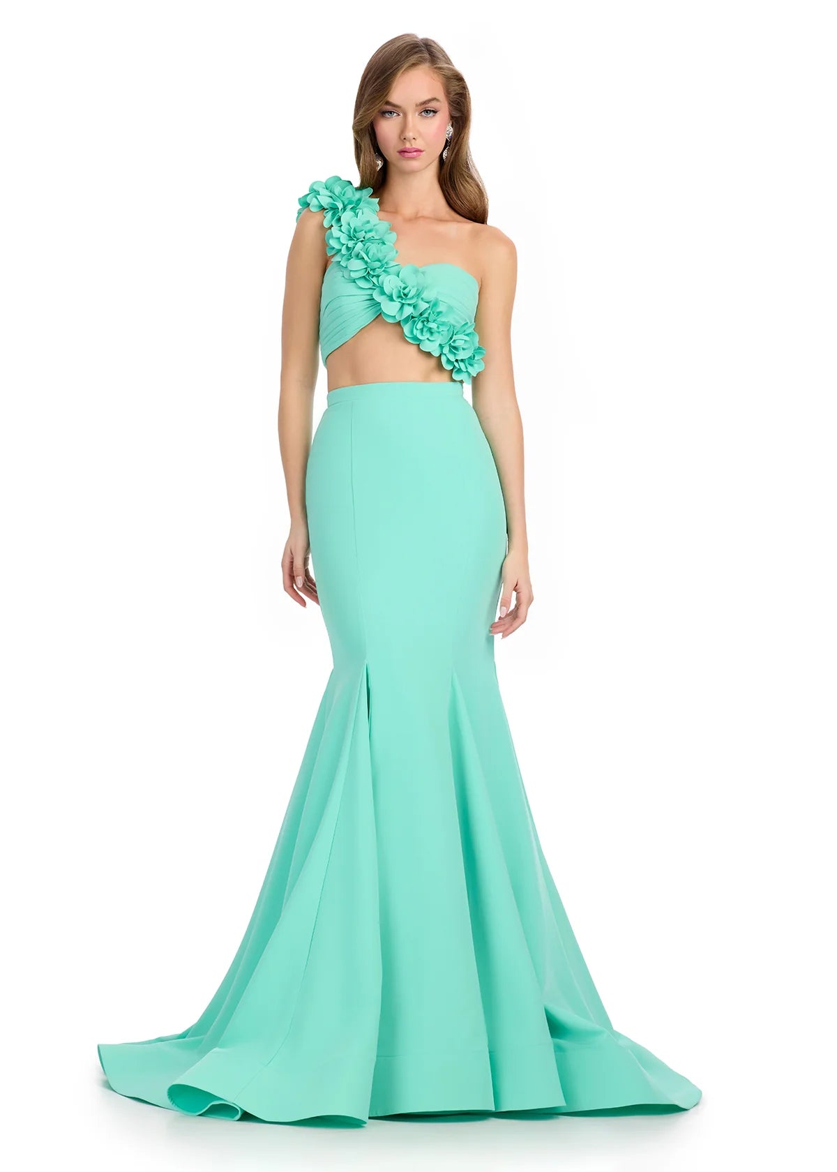 Mint green two-piece gown featuring a strapless floral-embellished crop top and a fitted mermaid skirt with a dramatic flared hemline.