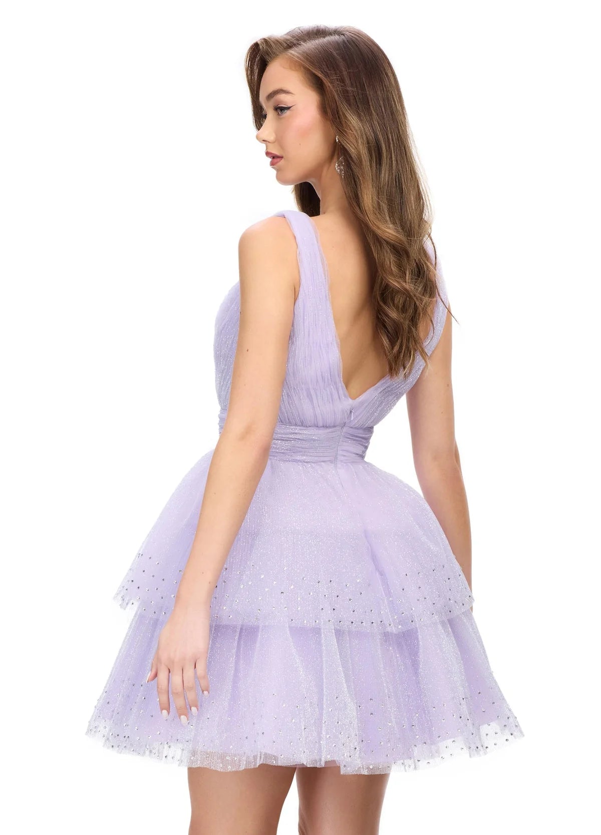 Lavender tiered mini dress featuring a plunging V-neckline, delicate tulle layers with sparkling accents, and a cinched waist for a fairytale-inspired look. Back view.