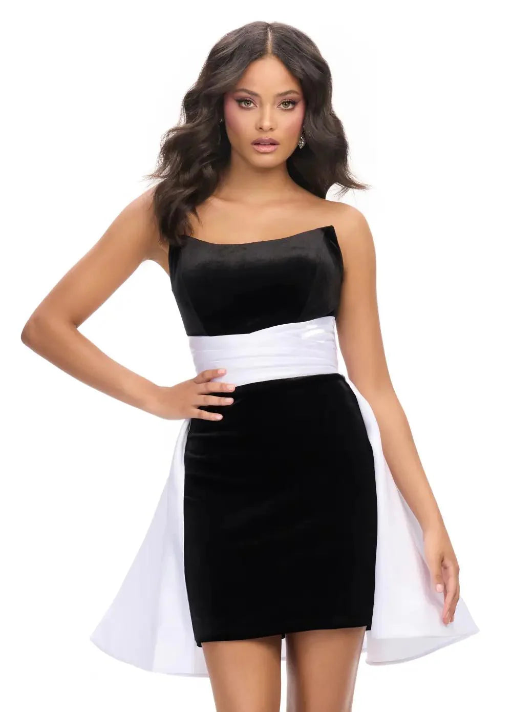 Black velvet mini dress with a white satin waist accent and an elegant cascading overskirt.