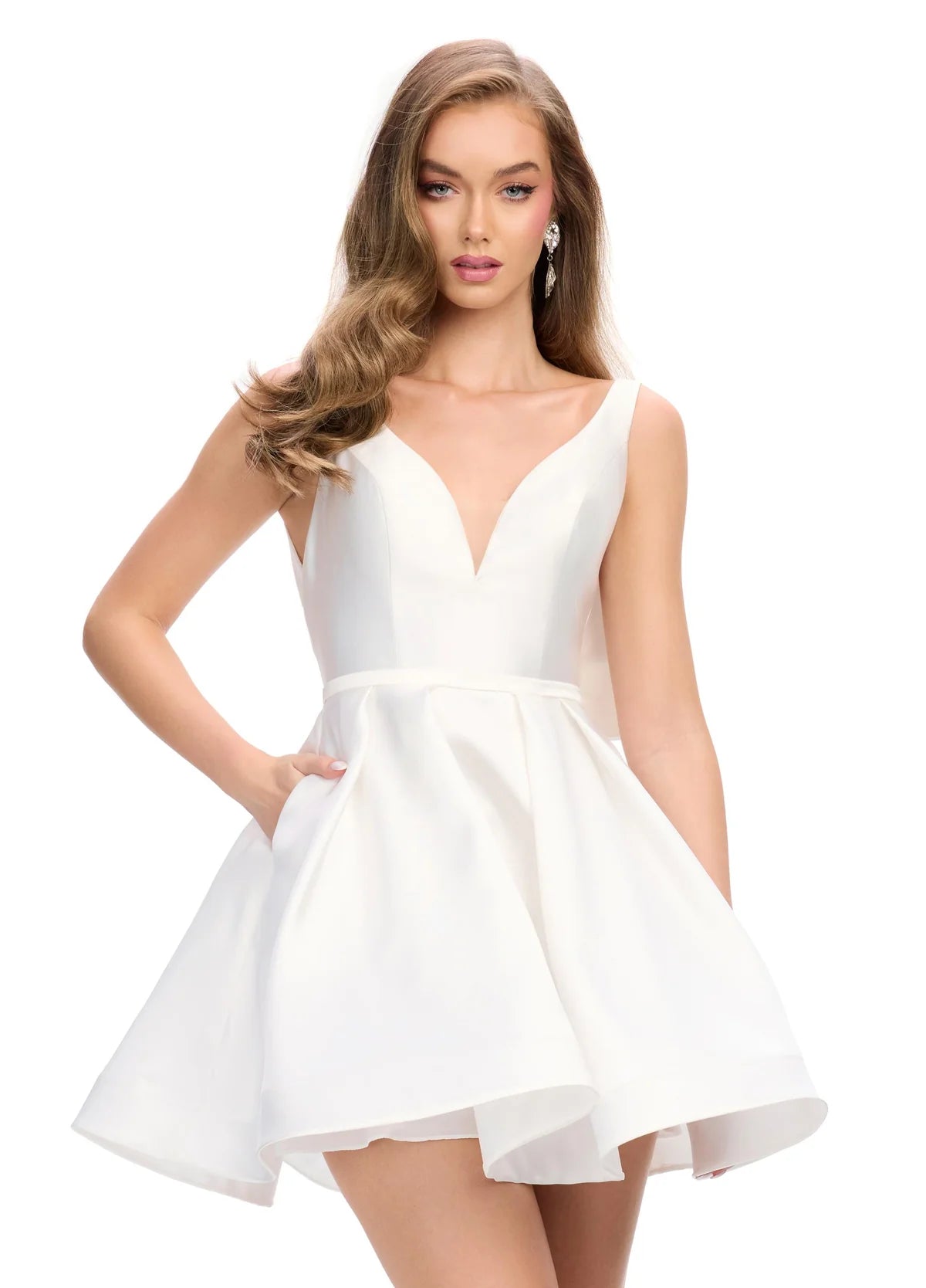 White sleeveless A-line cocktail dress featuring a deep V-neckline, fitted bodice, and a voluminous short skirt with subtle pleats, creating a playful and elegant look.