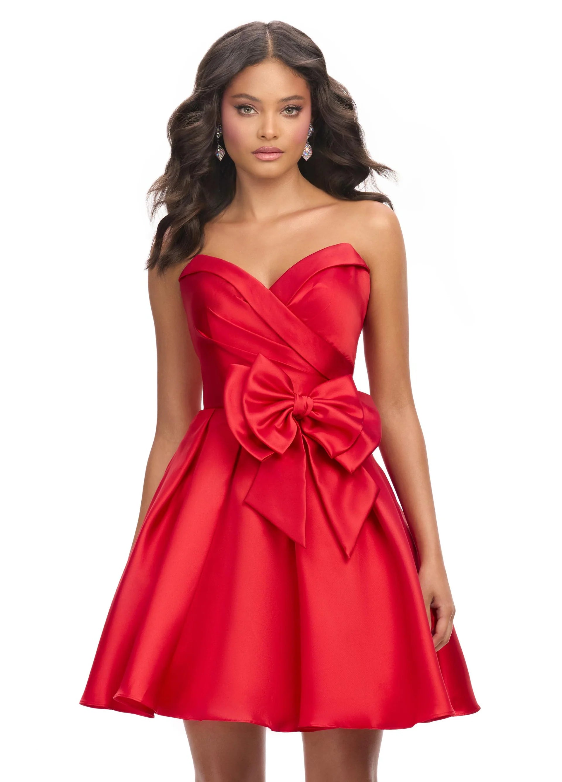 Strapless red mini dress featuring a sweetheart neckline, pleated bodice, and oversized bow accent for a playful and elegant look.