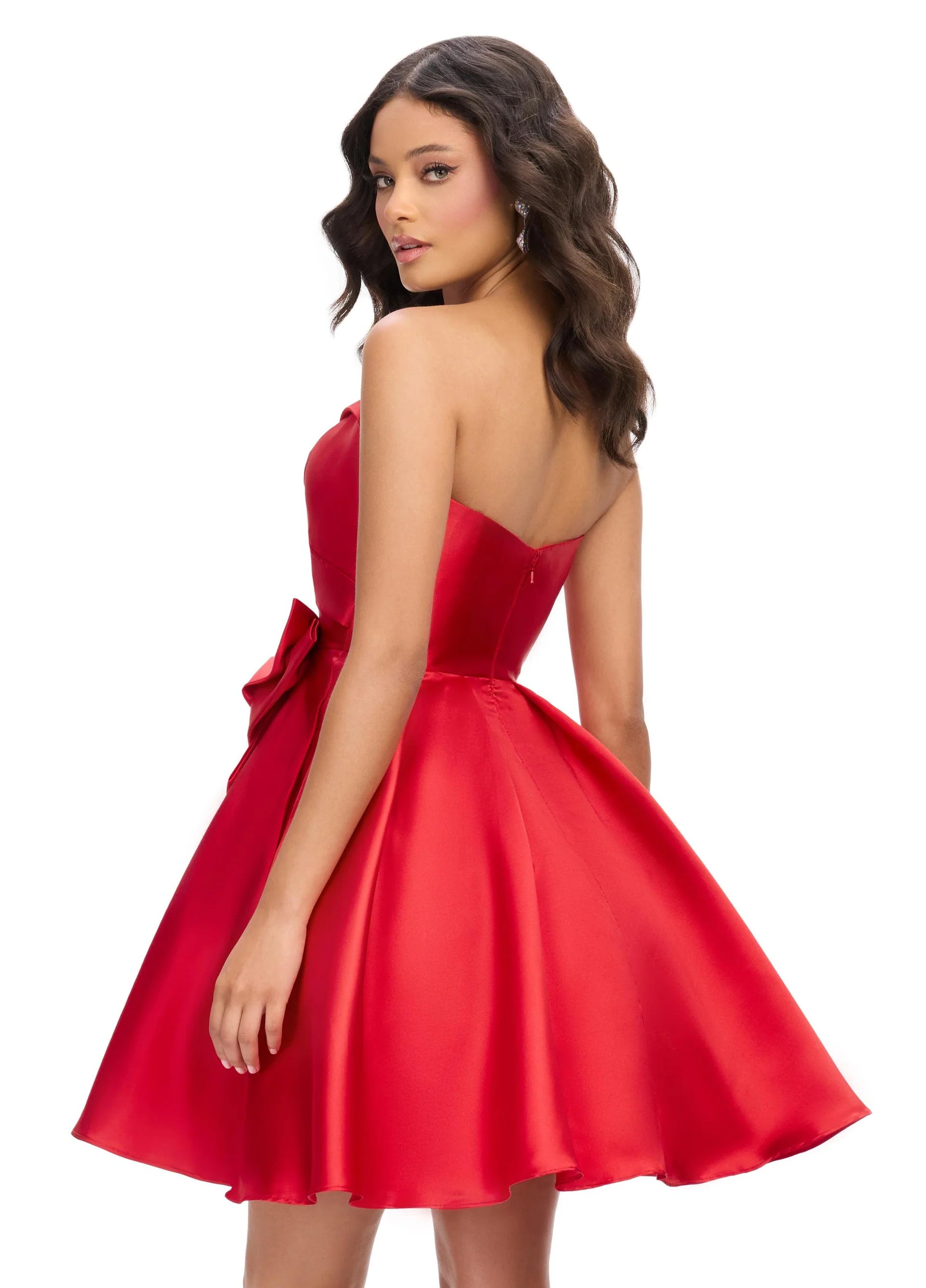 Back View  Strapless red mini dress featuring a sweetheart neckline, pleated bodice, and oversized bow accent for a playful and elegant look.