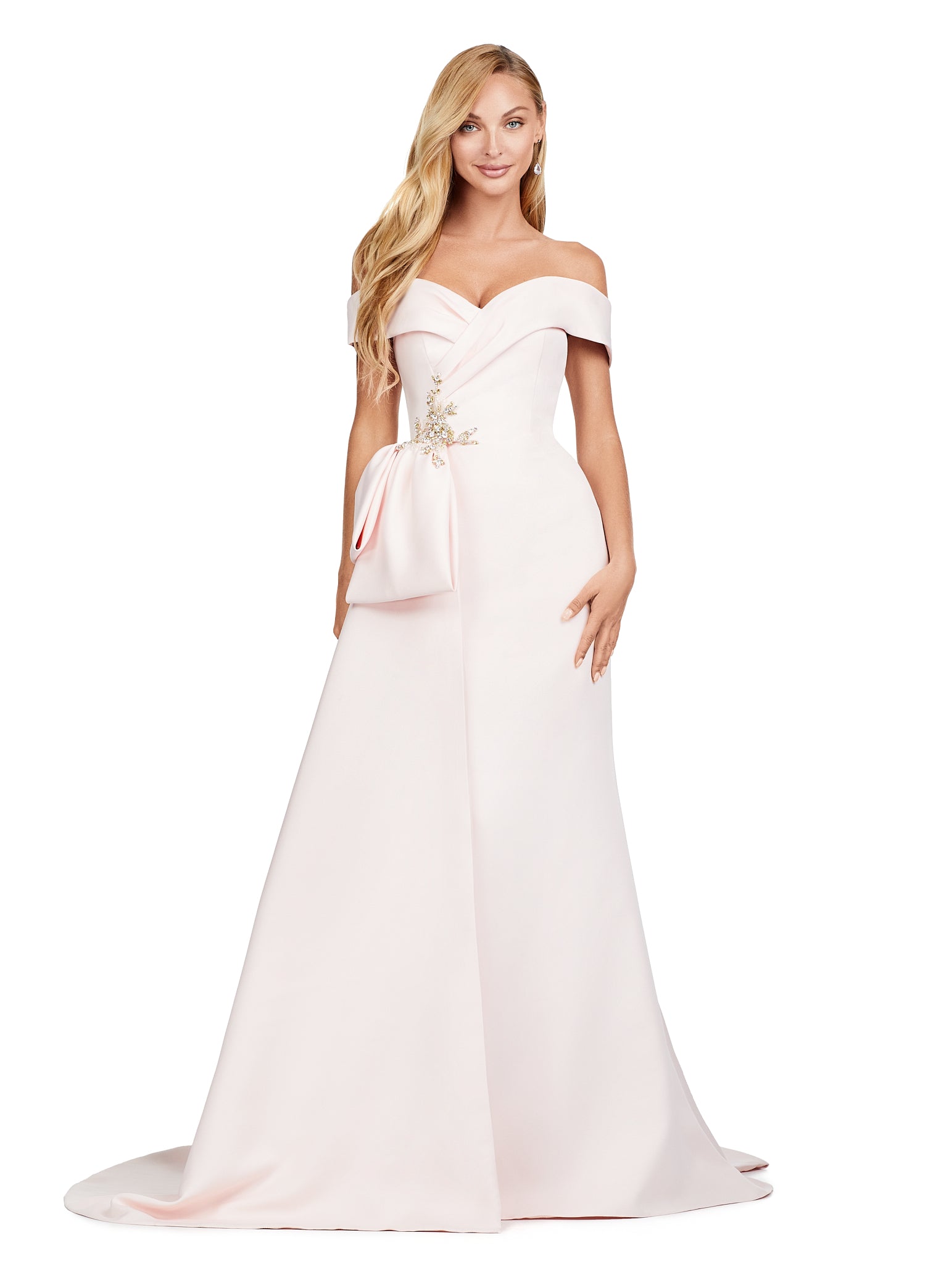 Blush-coloured evening gown featuring an off-the-shoulder neckline, elegant draped bodice, and statement side bow with intricate floral embellishment for added sophistication.