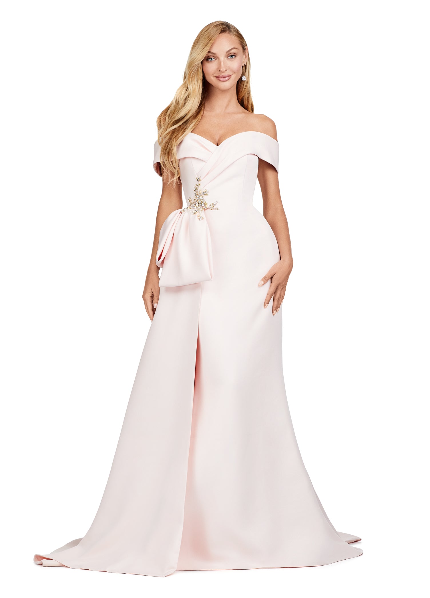 Blush-coloured evening gown featuring an off-the-shoulder neckline, elegant draped bodice, and statement side bow with intricate floral embellishment for added sophistication.