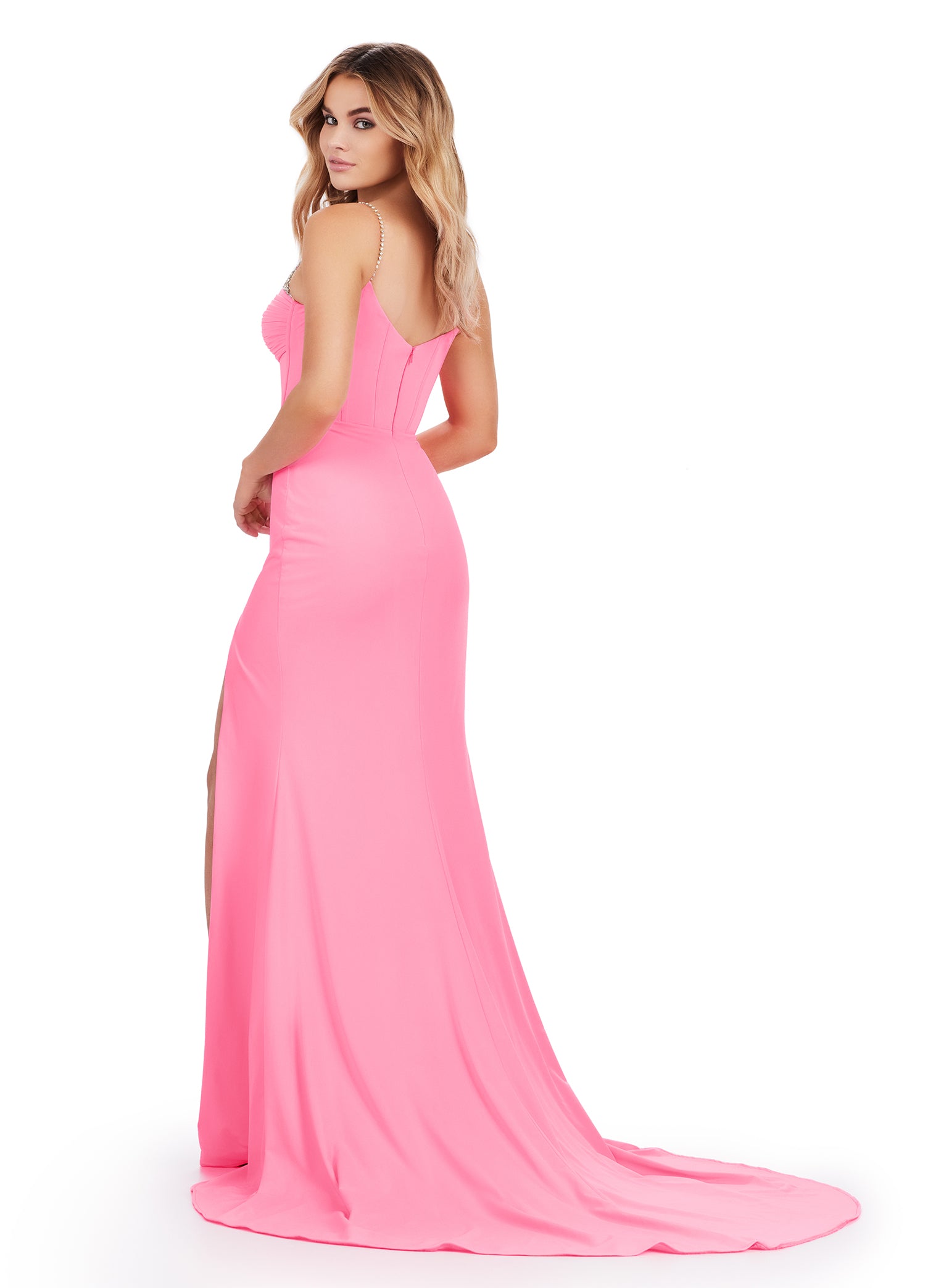 Back view - Pink floor-length gown featuring a structured sweetheart bodice adorned with shimmering embellishments, a dramatic thigh-high slit, and delicate ruching for an elegant silhouette.