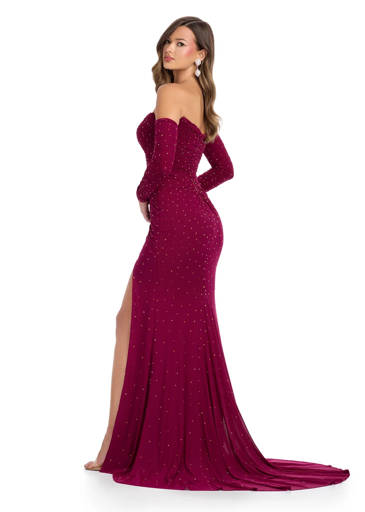 Back view - Elegant burgundy floor-length gown featuring an off-the-shoulder design, long fitted sleeves, ruched detailing, sparkling embellishments, and a thigh-high slit for a sophisticated and glamorous look.